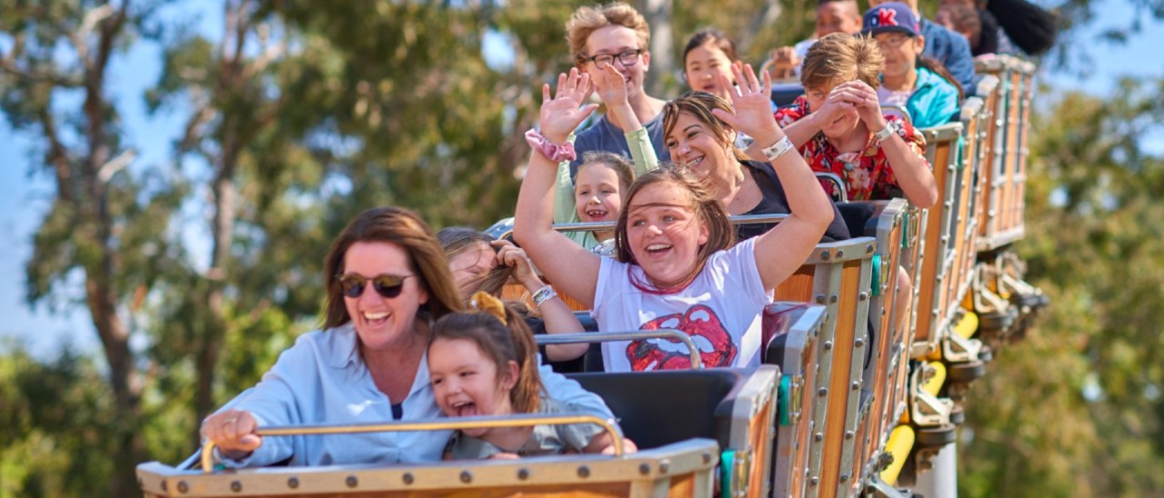 people riding a family rollercoaster
