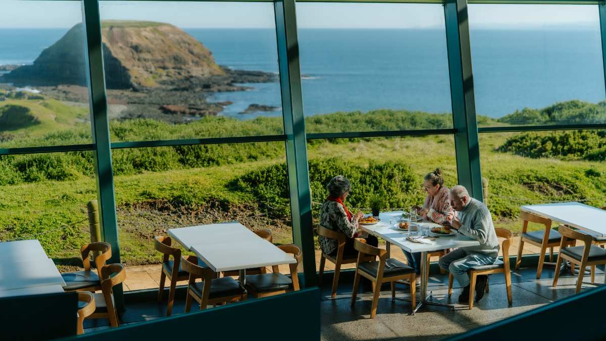 three people dining with views of The Nobbies