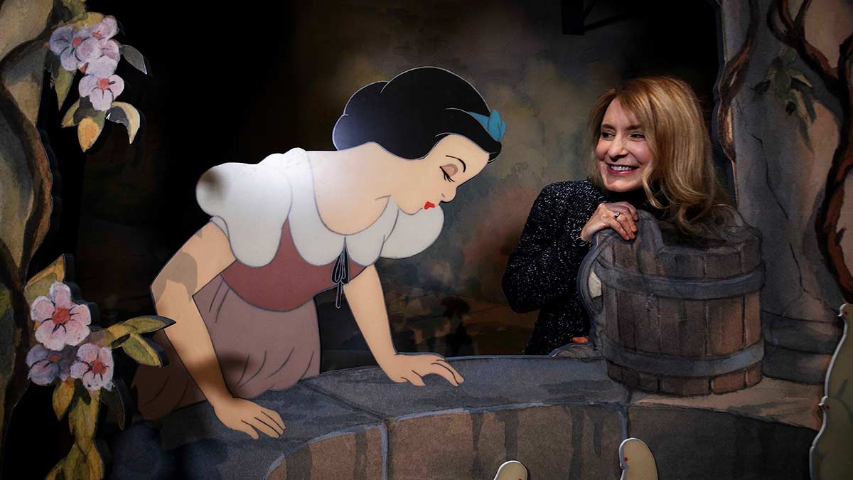 A woman enjoying the immersive Snow White exhibit at ACMI
