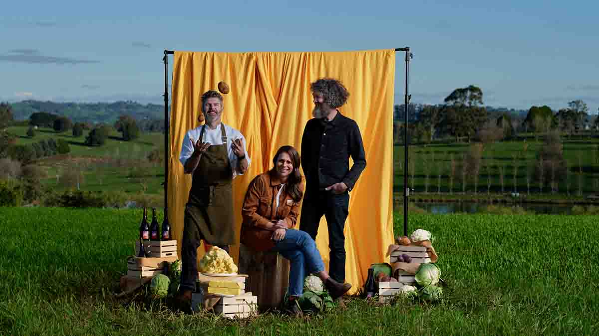 Chefs standing in field in front of yellow backdrop