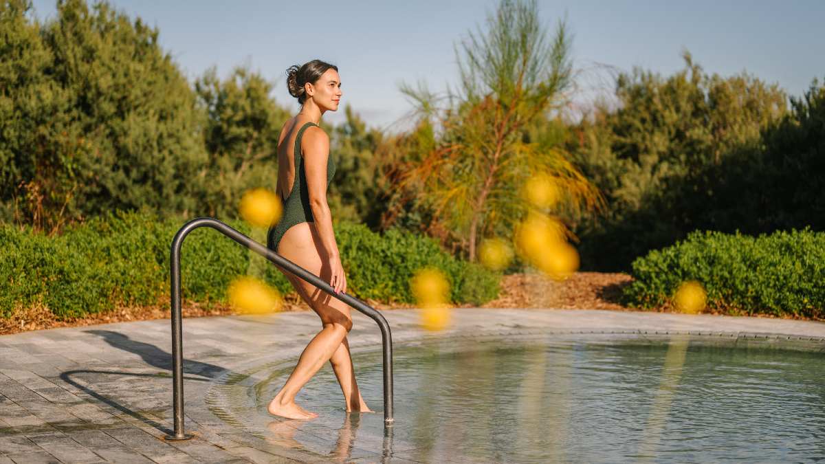 A waiter serving two people at a restaurant