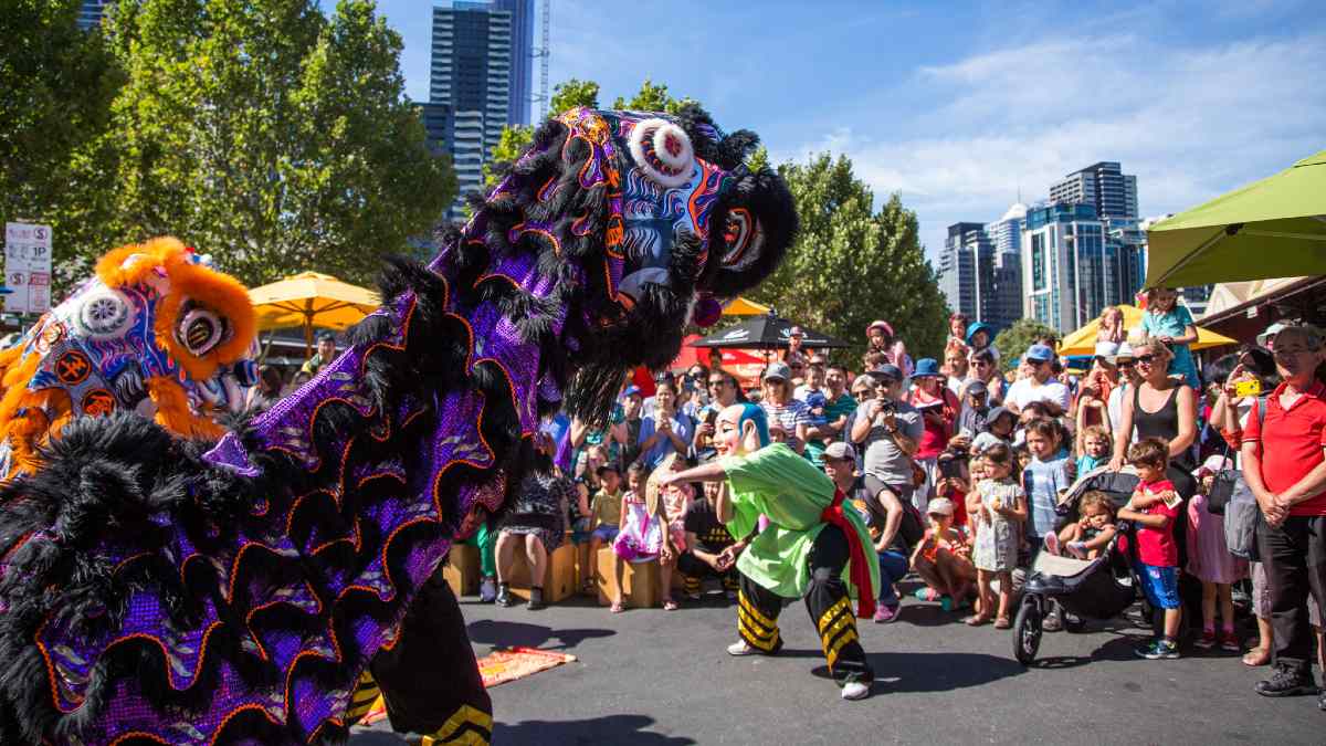 purple and orange dragons dancing at Queen Vic Market for Lunar New Year