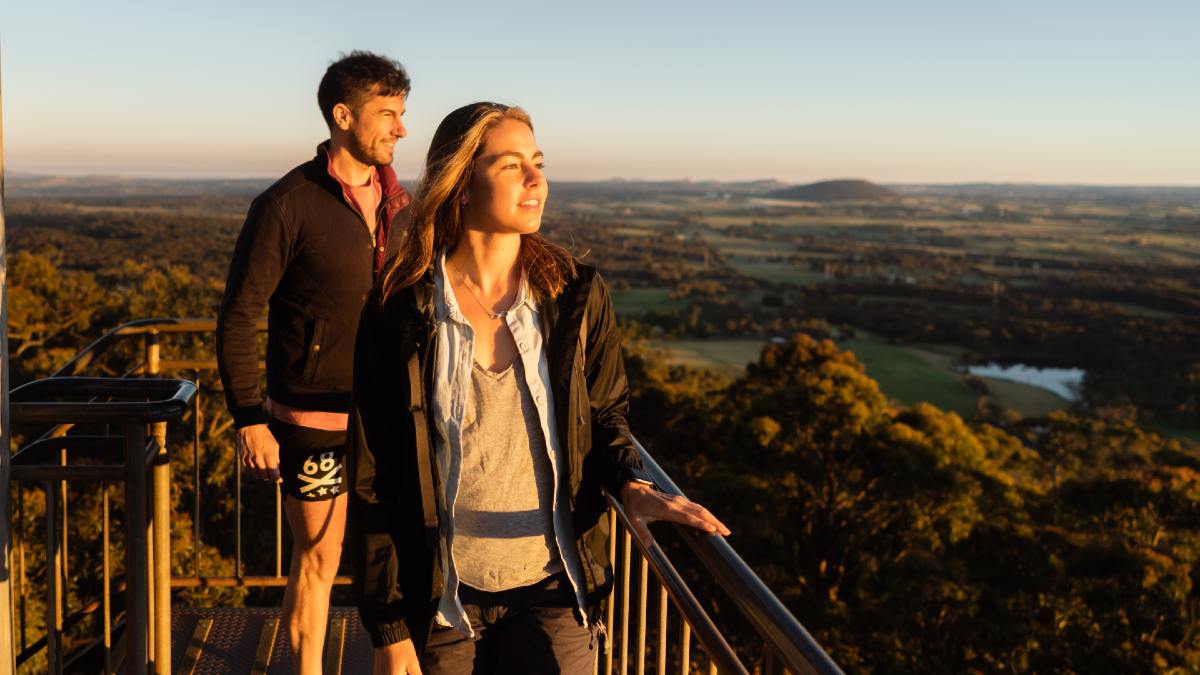 young couple at a lookout at sunset