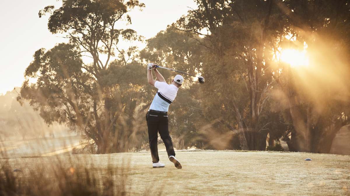 man swinging golf club