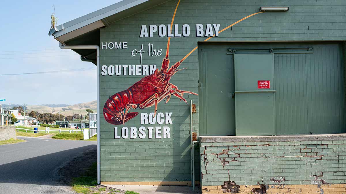 Building with picture of lobster on it and town in background